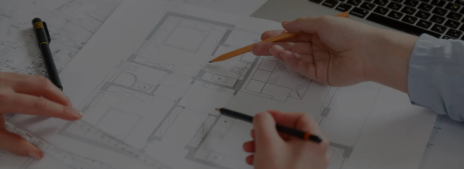 Hands pointing at an architectural floor plan