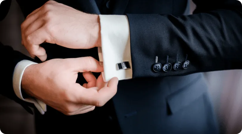 Man in a suit adjusting his cuff
